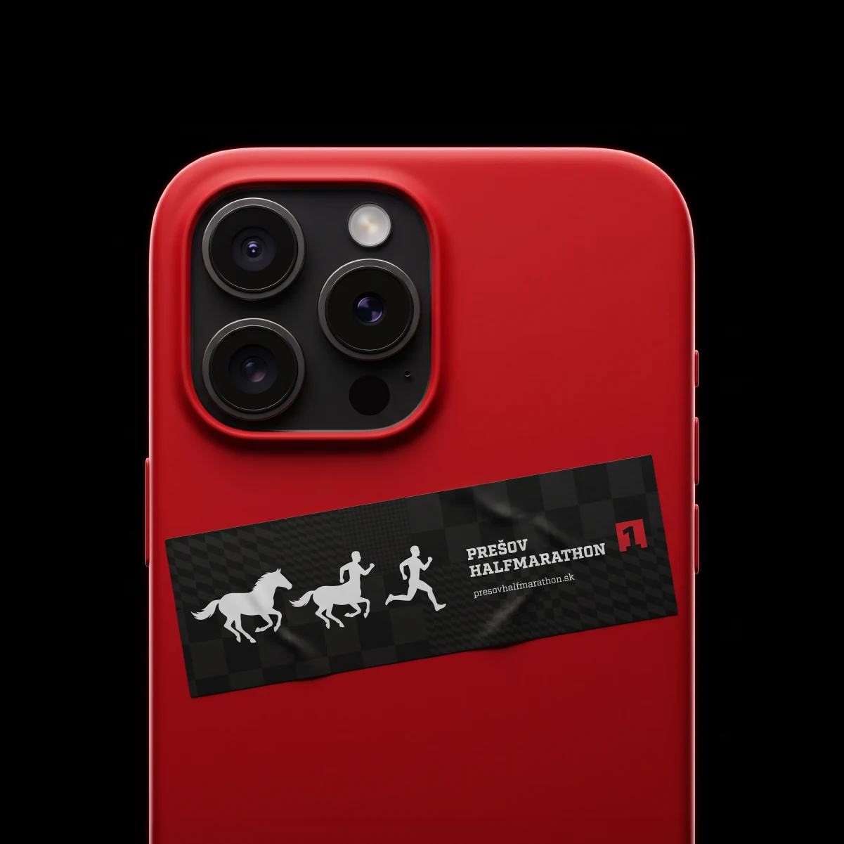 Red phone case with a Prešov Halfmarathon sticker featuring horses